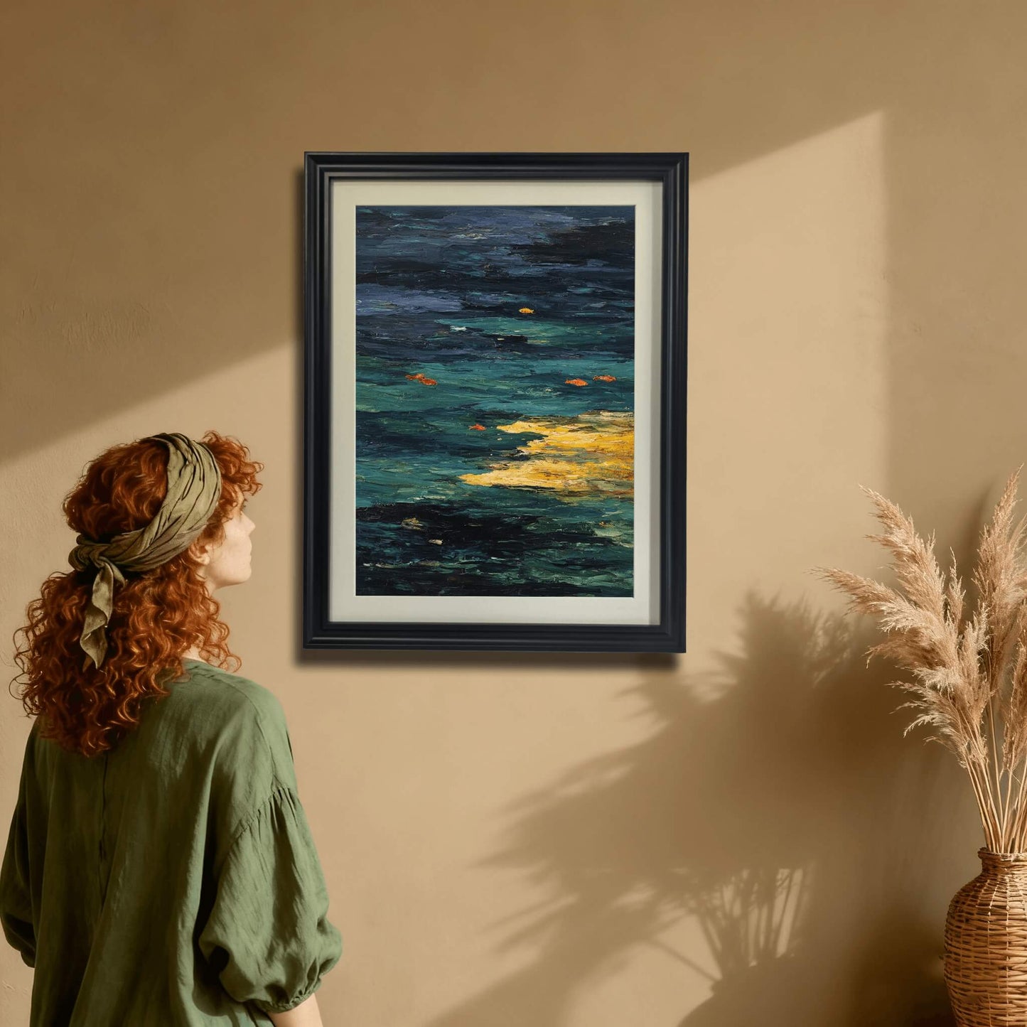Abstract Goldfish Pond art print in a black wood frame hanging on a tan wall. A woman in a green shirt is admiring the framed art, showing a rich, earthy interior decor style.