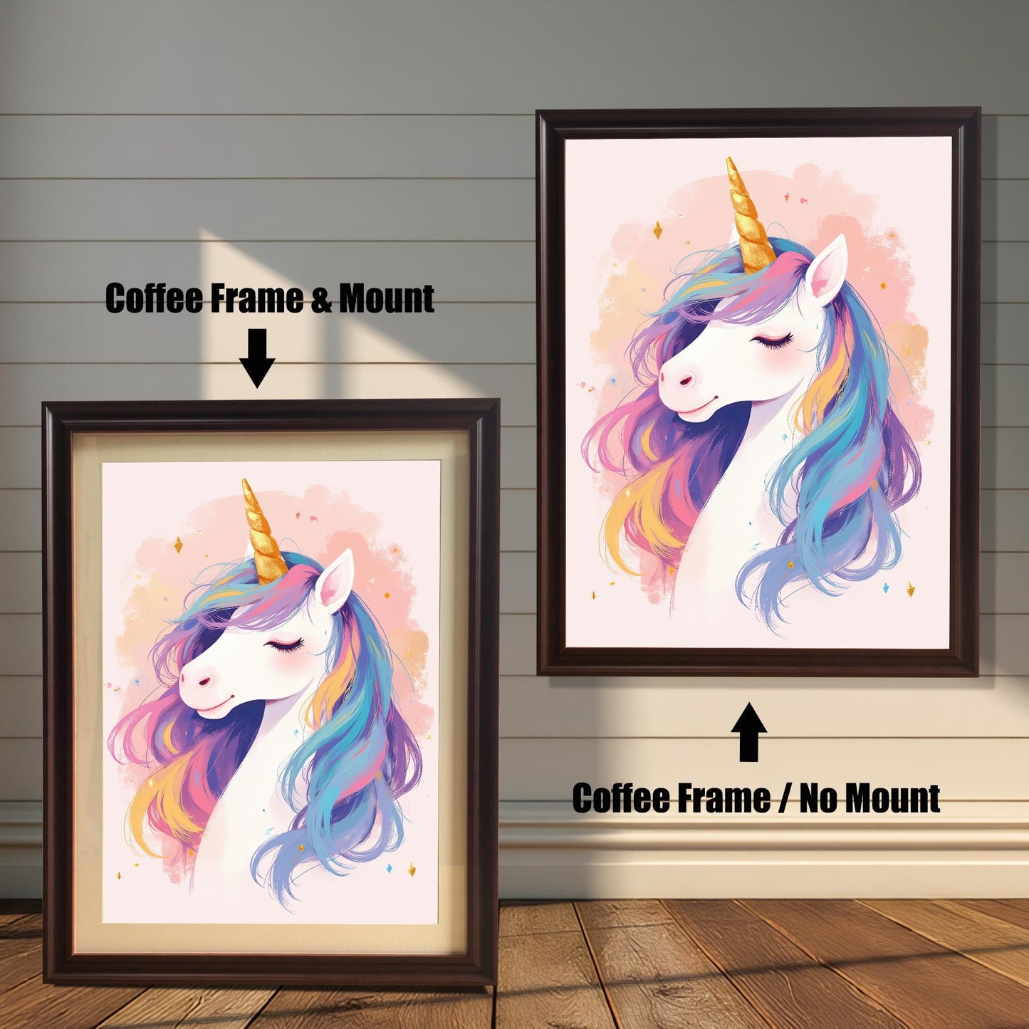 Two versions of a whimsical unicorn head art print with a coffee-colored wood frame. The print on the left is a smaller size framed with a white mount (or mat), and the one on the right is a larger size without a mount. The image shows the framed prints against a white paneled wall.