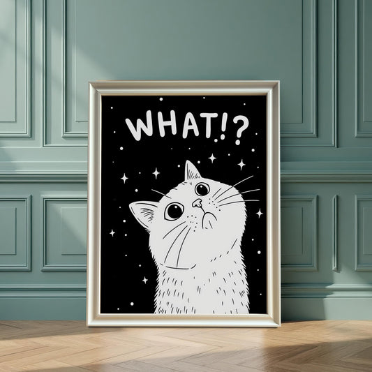 A framed print of a white cat with the text "WHAT!?" sits on a hardwood floor, leaning against a dark teal paneled wall.