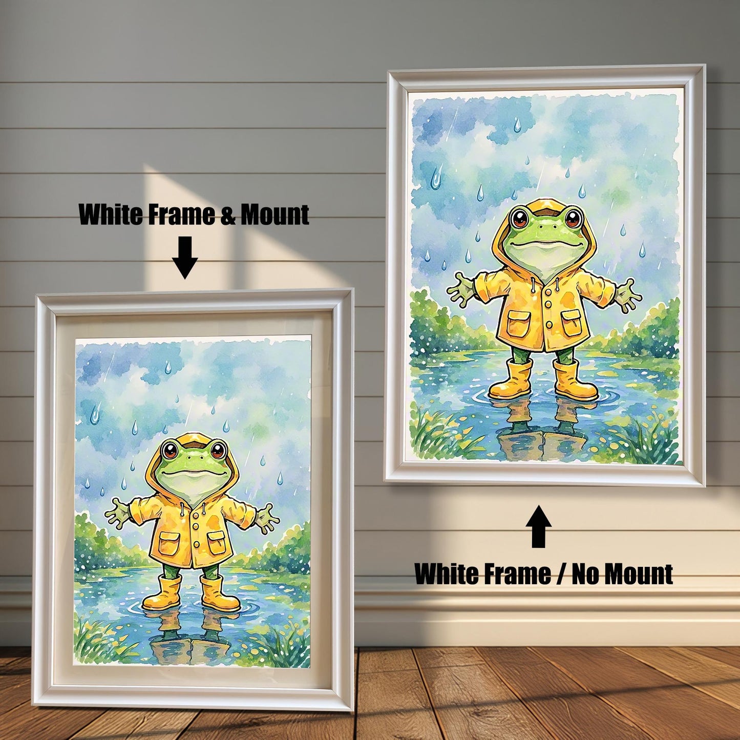 Two framed art prints of a frog in a raincoat. The image on the left has a white frame with a white mount, while the one on the right has a white frame with no mount.