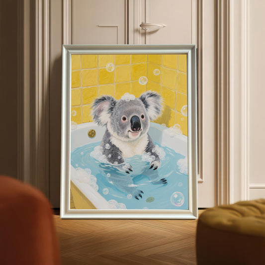A framed print of a koala in a bubble bath leaning against a white wardrobe. The frame is a silvery-white color. The art is centered and the image is a full shot of the framed print and its surroundings.