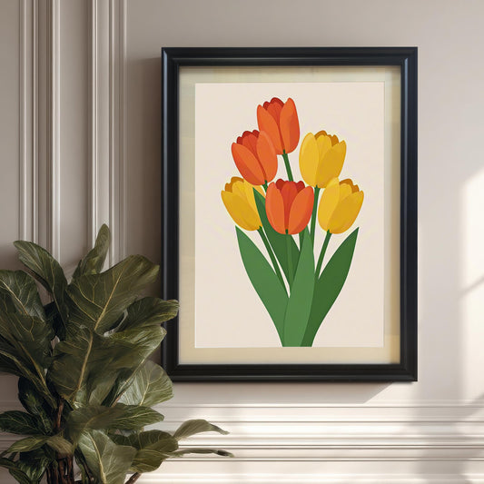 A black-framed art print of orange and yellow tulips hangs on a light wall above a plant in a pot.
