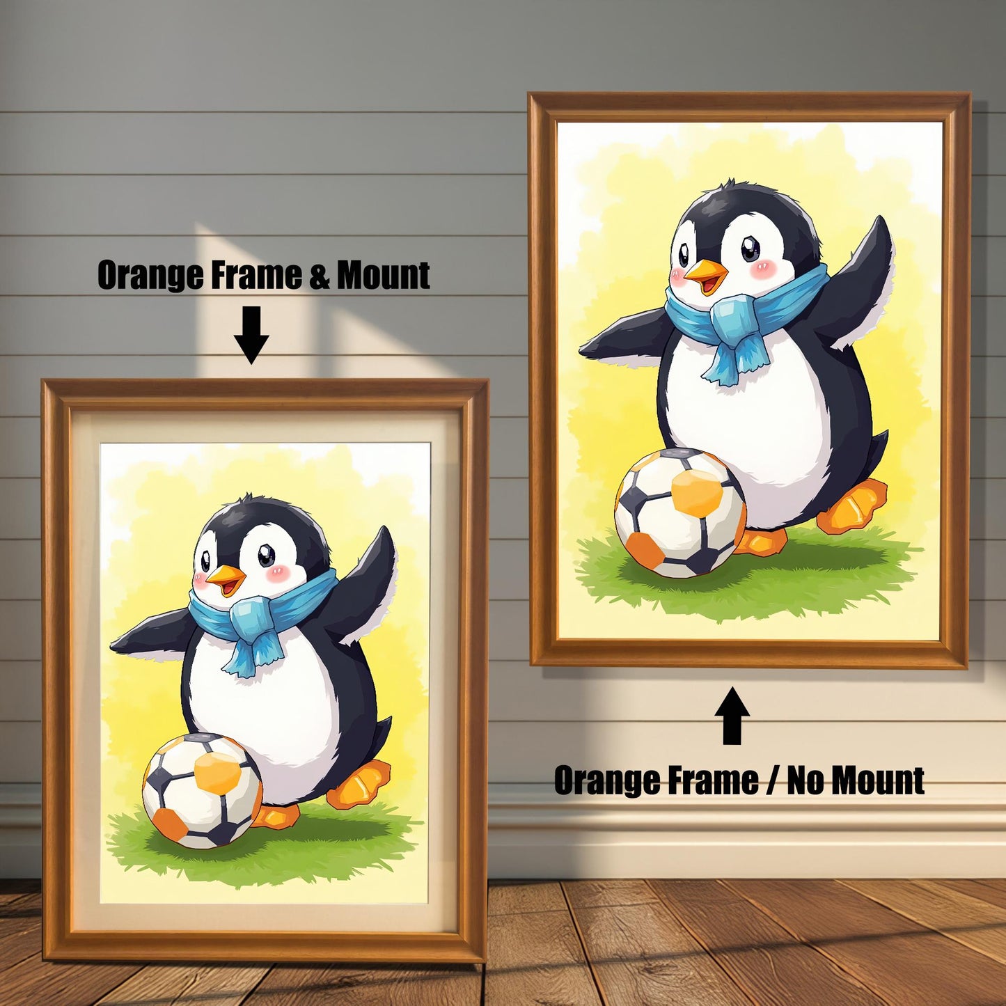 Two framed prints of a penguin playing soccer on a white wood-paneled wall. The one on the left has an orange frame with a mount. The one on the right has an orange frame with no mount.