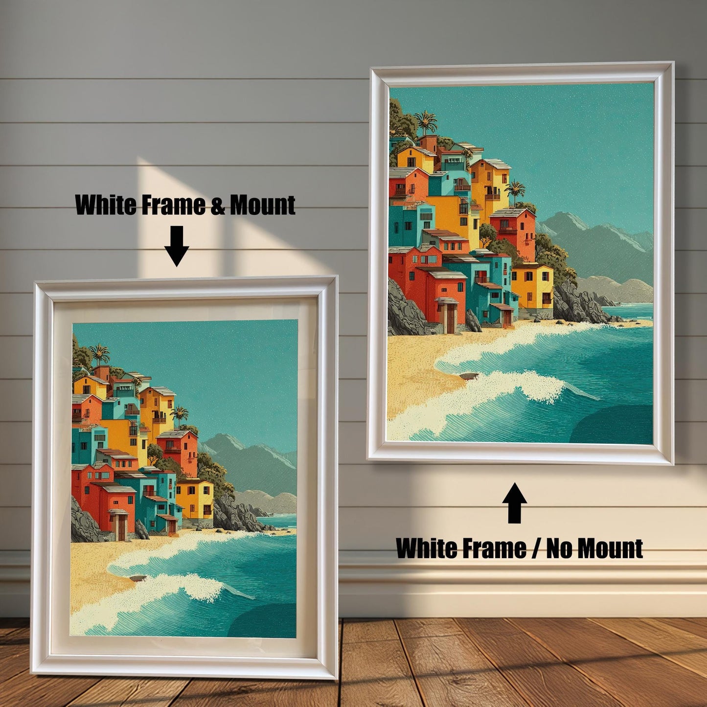 Two framed art prints are shown. The one on the left has a white frame with a mount, and the one on the right has a white frame with no mount. The print itself shows colorful houses on a beach.