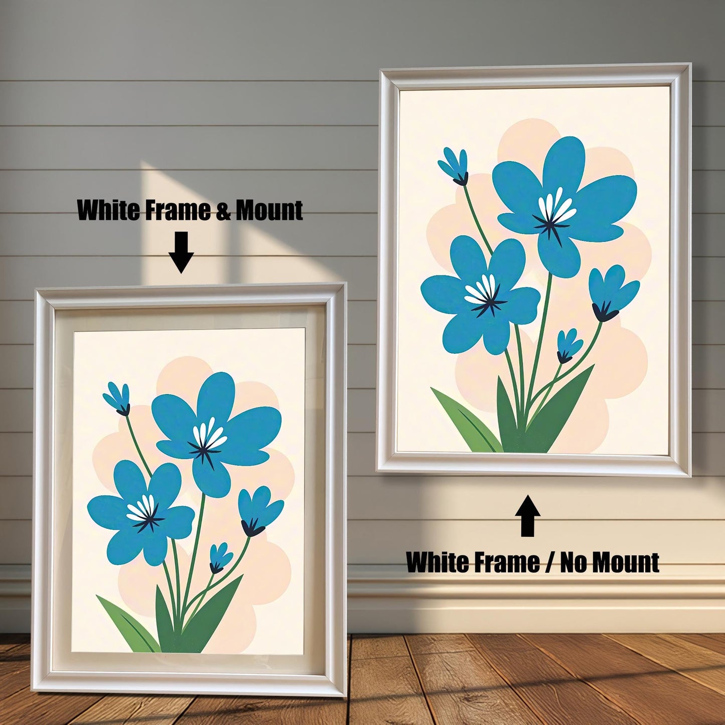 A side-by-side comparison of two white-framed prints of a blue flower painting. The print on the left is smaller with a mount (matting), while the larger one on the right has no mount.