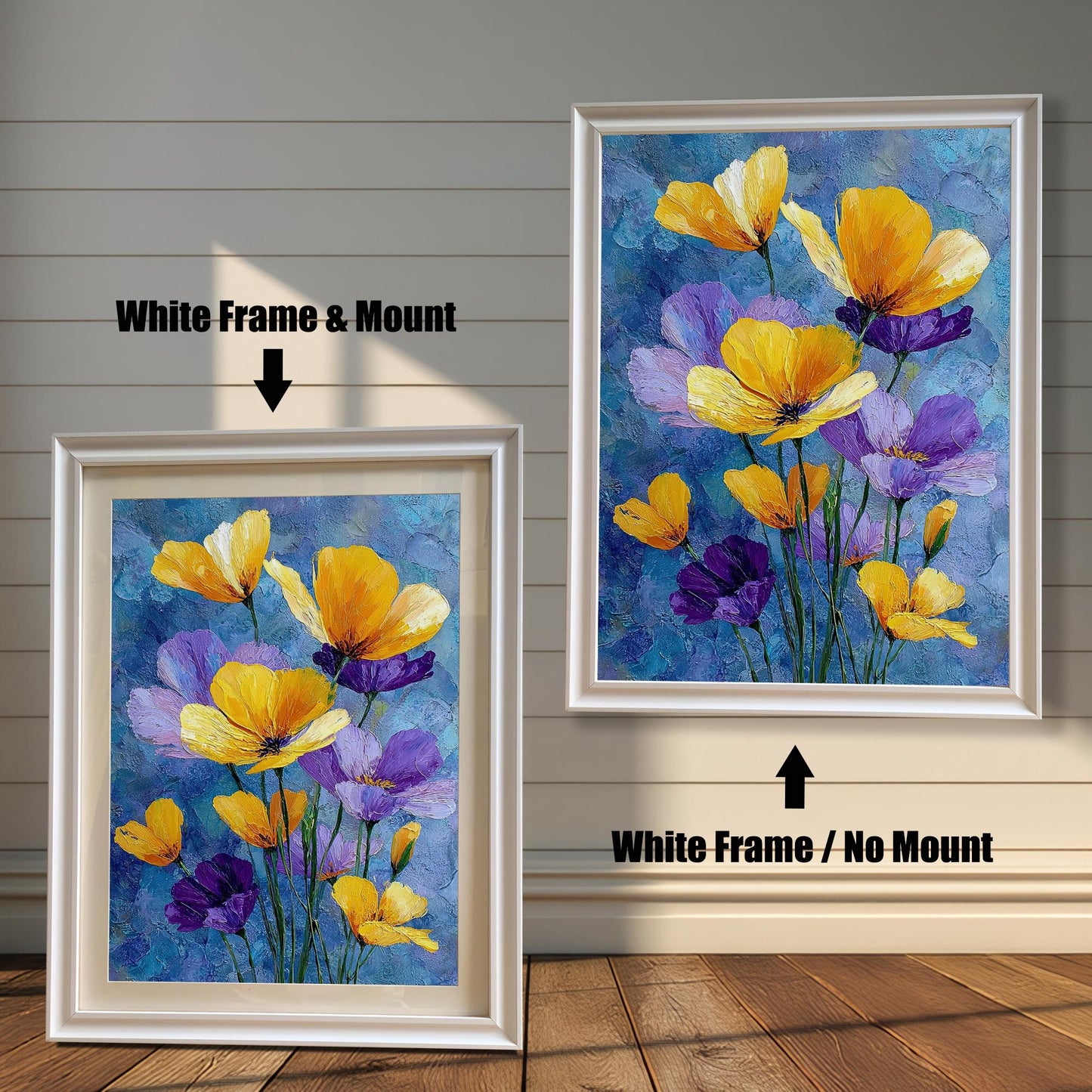 Two framed art prints of yellow and purple flowers on a wooden floor. The print on the left is in a white frame with a mount, and the one on the right is in a white frame without a mount.
