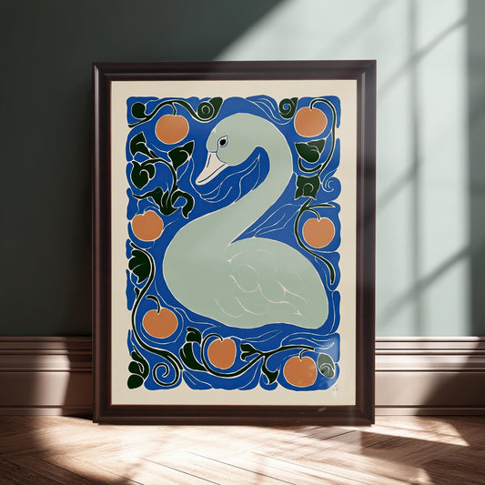 The framed swan print leaning on a baseboard against a dark teal wall, illuminated by a beam of sunlight. The frame is a deep brown or mahogany color.