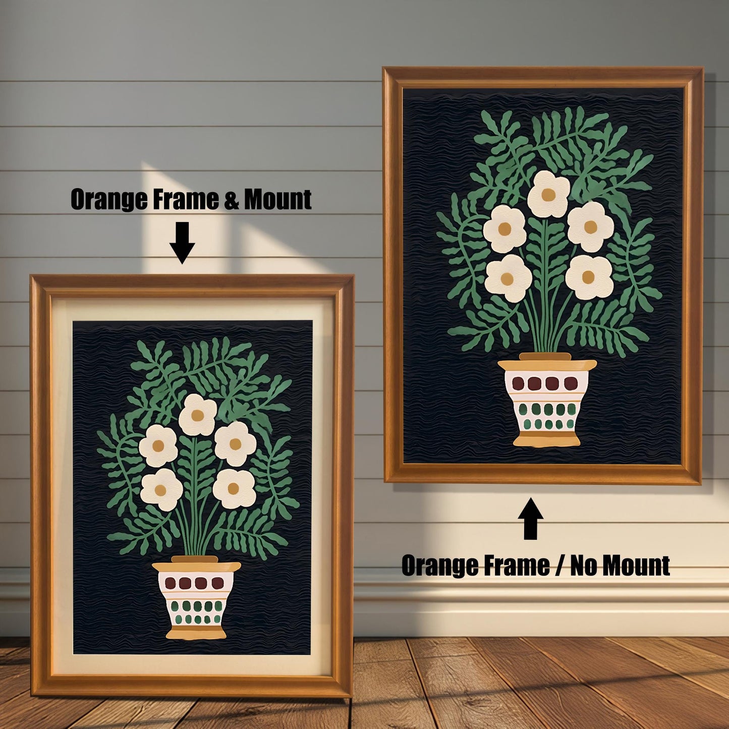 A comparison of two framed art prints showing an off-white floral bouquet in a pot against a dark background. One is an Orange Frame & Mount (matting), and the other is an Orange Frame / No Mount.