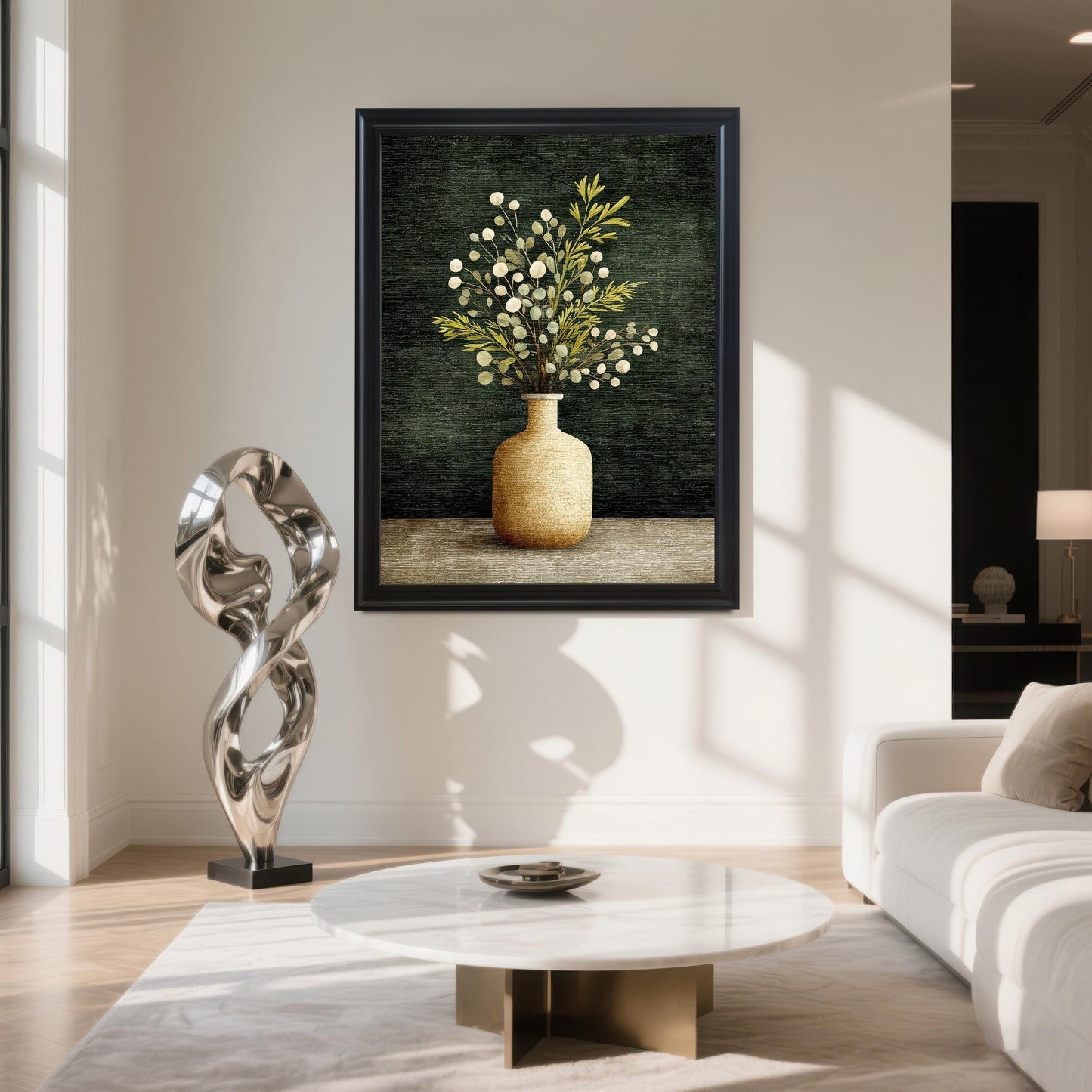 A large framed art print of a vase with green and white foliage, hanging on a white wall in a modern living room. The frame is Black. Below the print are a marble coffee table and a silver abstract sculpture.