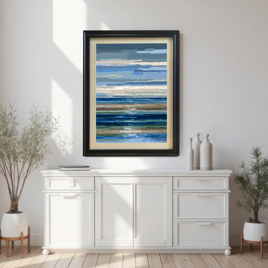 Abstract blue, white, and brown horizontal striped seascape print in a black wood frame with a light mount, hanging above a white console table in a modern room.