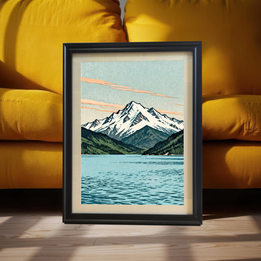 A vertical black wood framed mountain art print leaning against a bright yellow upholstered sofa on a light wood floor with natural sunlight and shadows.