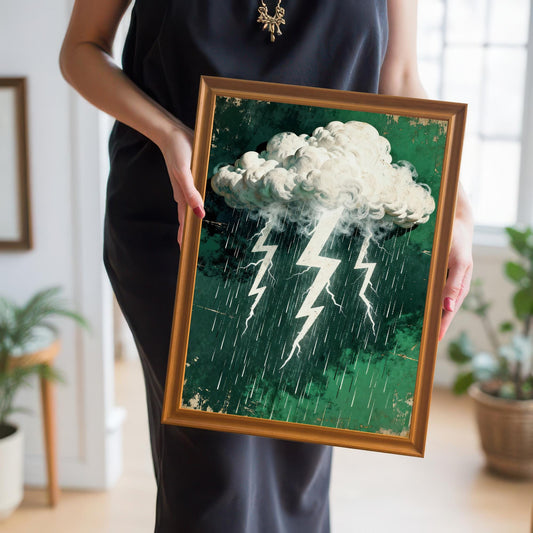 A person in a black dress holding the stormy cloud and lightning art print in a gold-colored 'Orange' wood frame, showing the scale and dramatic colors.