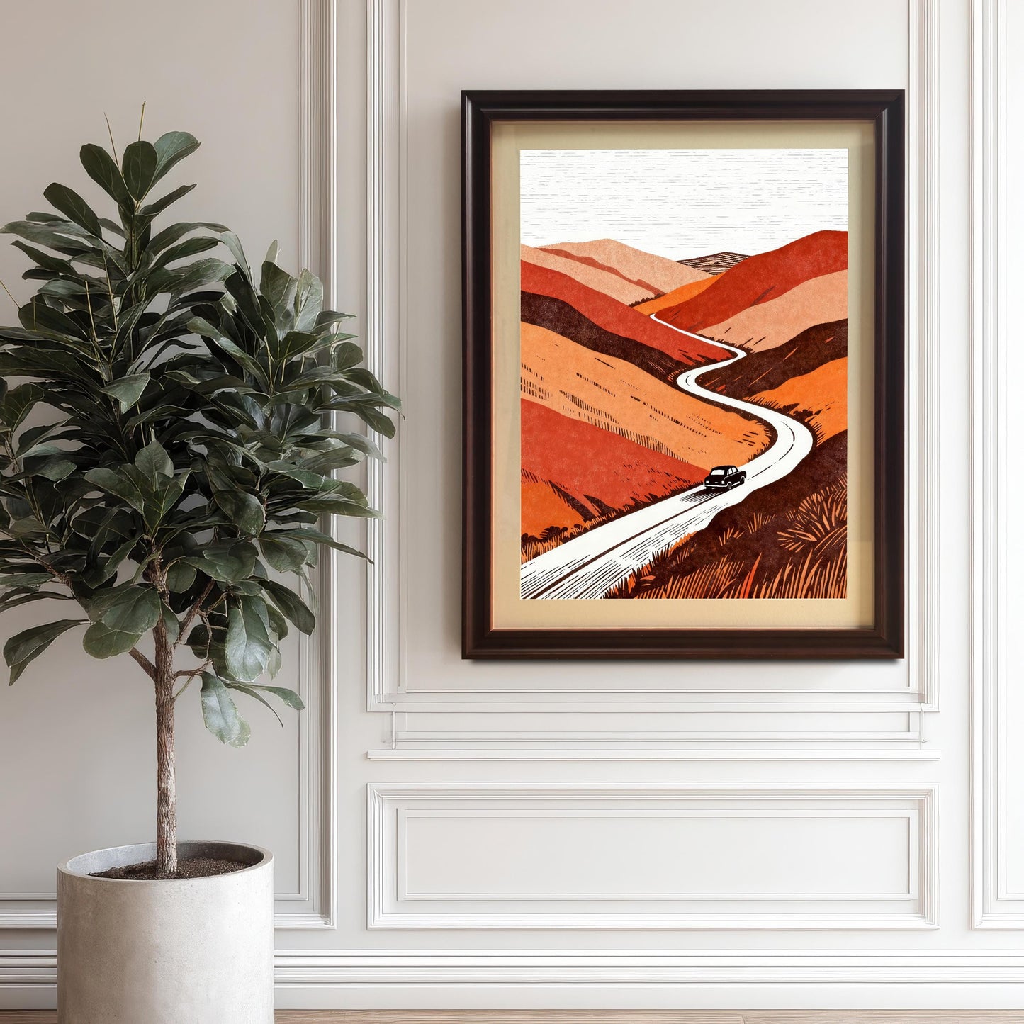 Dark brown "Coffee" wood-framed art print with an off-white mat (mount) hanging on a classic white wainscoted wall next to a large potted indoor tree.