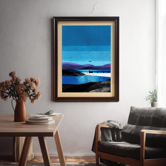 A lifestyle shot of a modern living room featuring the "Coffee" brown wood-framed blue landscape art print with an off-white mount, hanging on a white wall above a wooden table and a dark leather chair.
