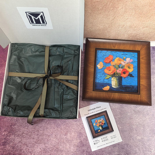 A 'Midnight Flora' unboxing set by Miracle Walls. The vibrant, textured oil-style floral print is showcased in a dark wood frame alongside premium gift packaging with green tissue paper, a gold-striped ribbon, and a signed artist certificate.