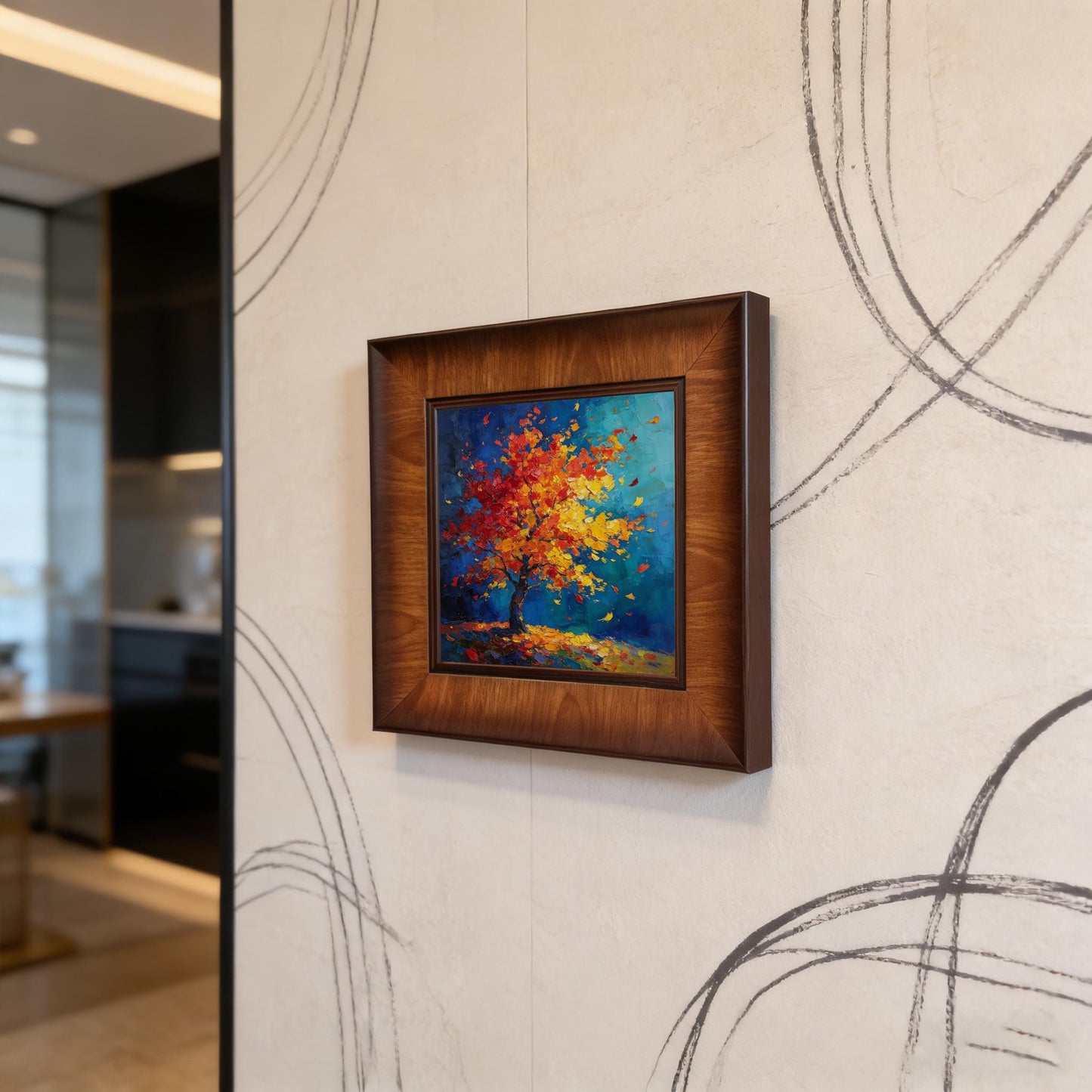 A square wood-framed abstract painting of a colorful autumn tree with red and yellow leaves is mounted on a modern textured wall featuring dark geometric linear patterns.