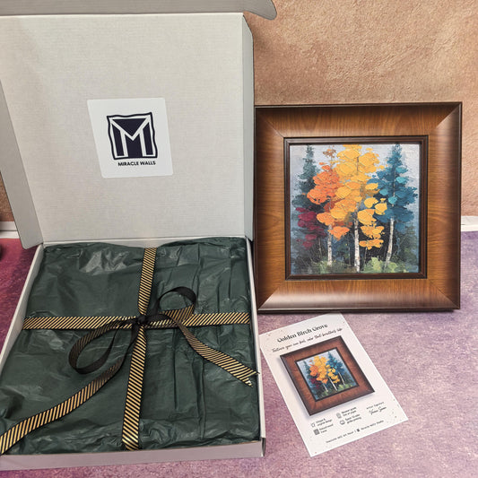 An unboxing presentation of the "Golden Birch Grove" print. The square framed artwork is displayed next to an open "Miracle Walls" gift box featuring premium green tissue paper and a gold-accented ribbon, alongside a product specification card.