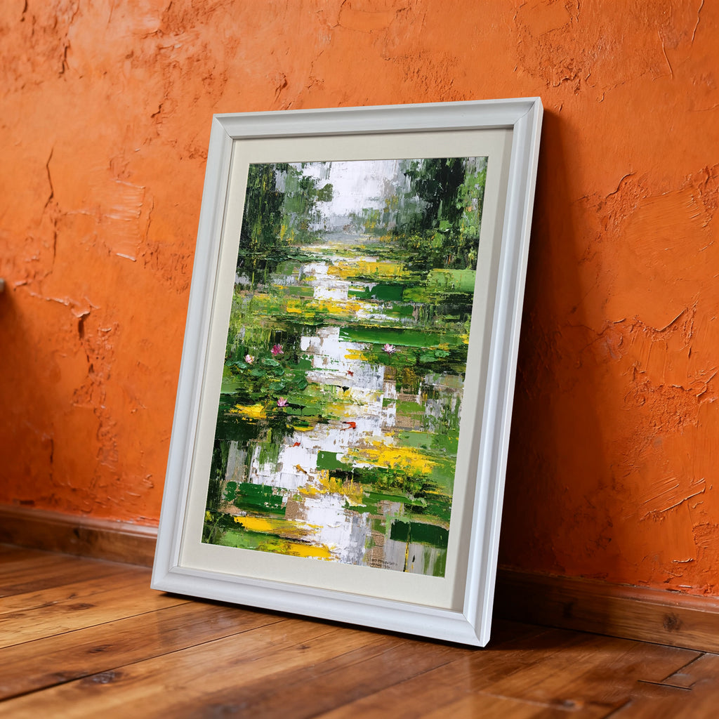Abstract impressionist oil painting of a lily pond with green, yellow, and white brushstrokes, framed in white, leaning against a rustic orange textured wall and wood floor.
