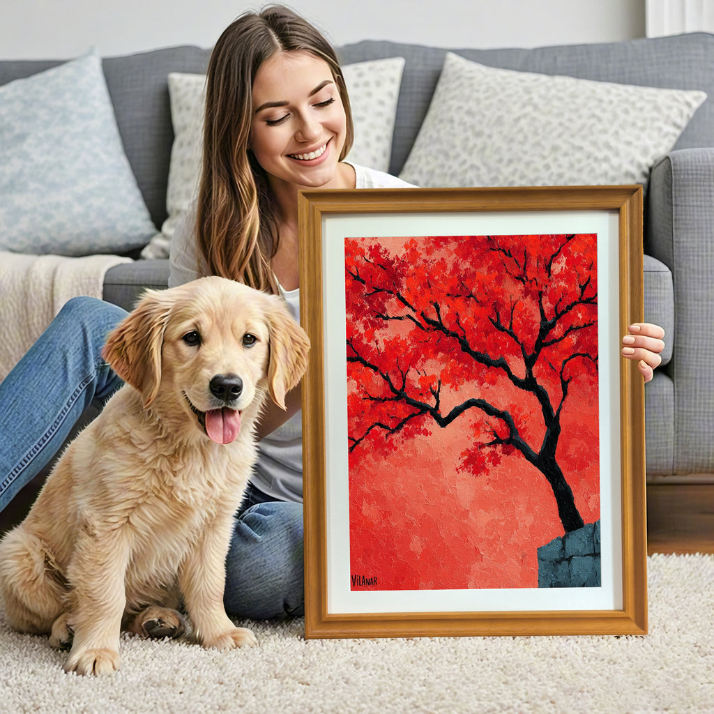 A smiling woman sits on a shag rug next to a golden retriever puppy, holding a gold-framed painting of a red-orange tree. A gray sofa with pillows is visible in the background.