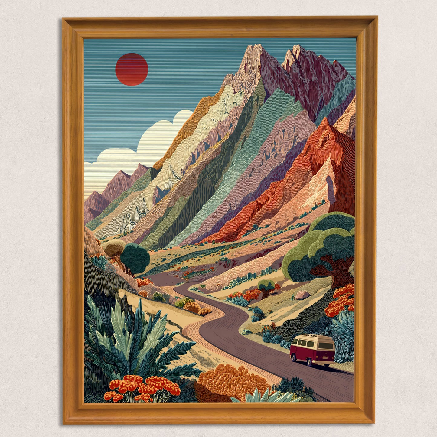 Close-up of a natural wood-framed art print featuring a winding road, a vintage van, and a colorful, layered mountain landscape under a red sun.