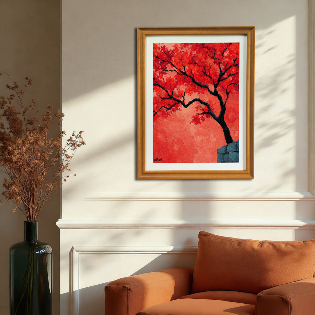 A vertical, gold-framed painting of a red-orange tree is hanging on a beige wall with white wainscoting, positioned above an orange chair. Strong sunlight casts a shadow on the wall.