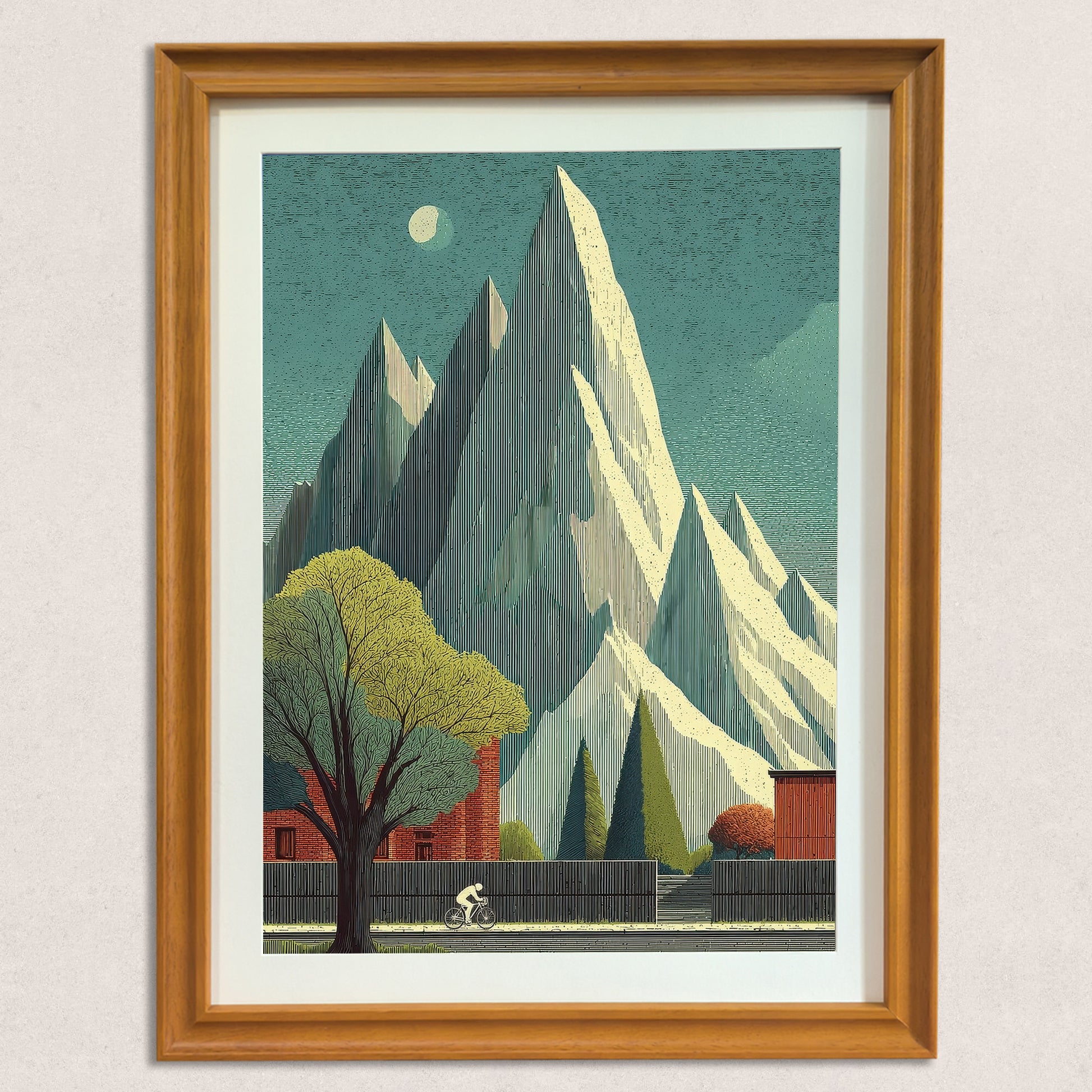 Close-up shot of the mountain and cyclist art print framed in natural wood, against a textured neutral wall. The artwork has a vintage, graphic style.