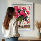 A woman in a white sweater stands looking at a large, white-framed painting of pink roses in a vase against a distressed background, hanging above a light wood console table in a bright room.