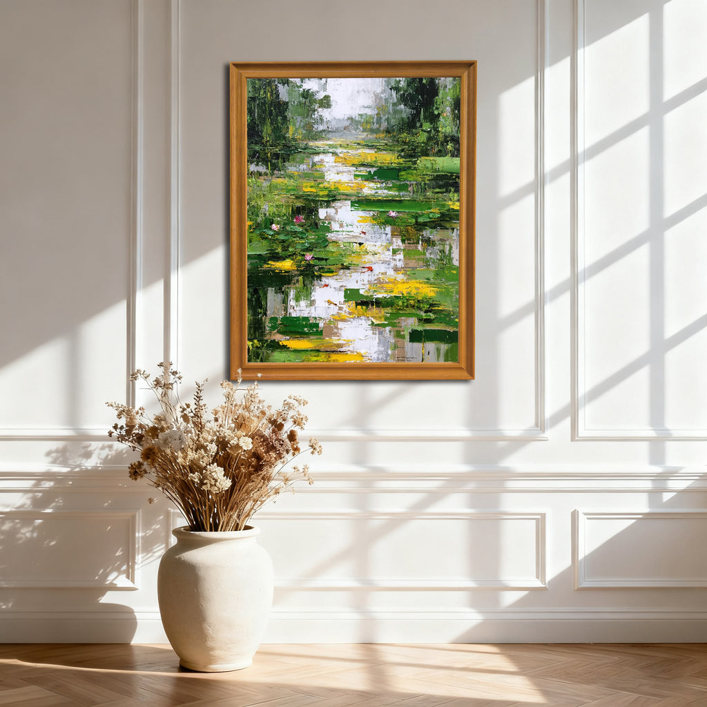Abstract lily pond painting in a gold-colored wooden frame, hanging on an elegant white wall with decorative wainscoting and natural light creating strong window pane shadows, above a large white vase with dried flowers.