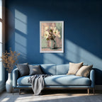 Abstract floral art print in a white frame, featuring white flowers in a pale vase against a textured pastel background, hanging above a light blue sofa on a deep blue wall.
