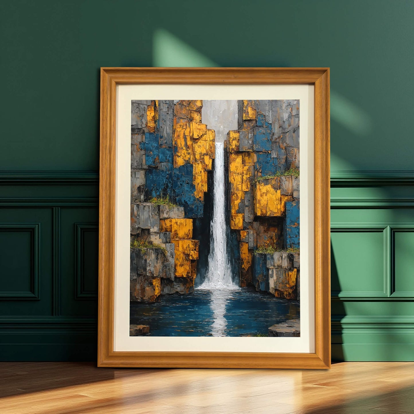 Abstract waterfall art print with a light mat in a natural wood frame, leaning on a dark green wainscoted wall.
