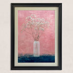 Close-up of the art print: small white flowers (baby's breath) in a tall, slender vase against a textured, vibrant pink wall and a contrasting dark blue surface, framed in black.