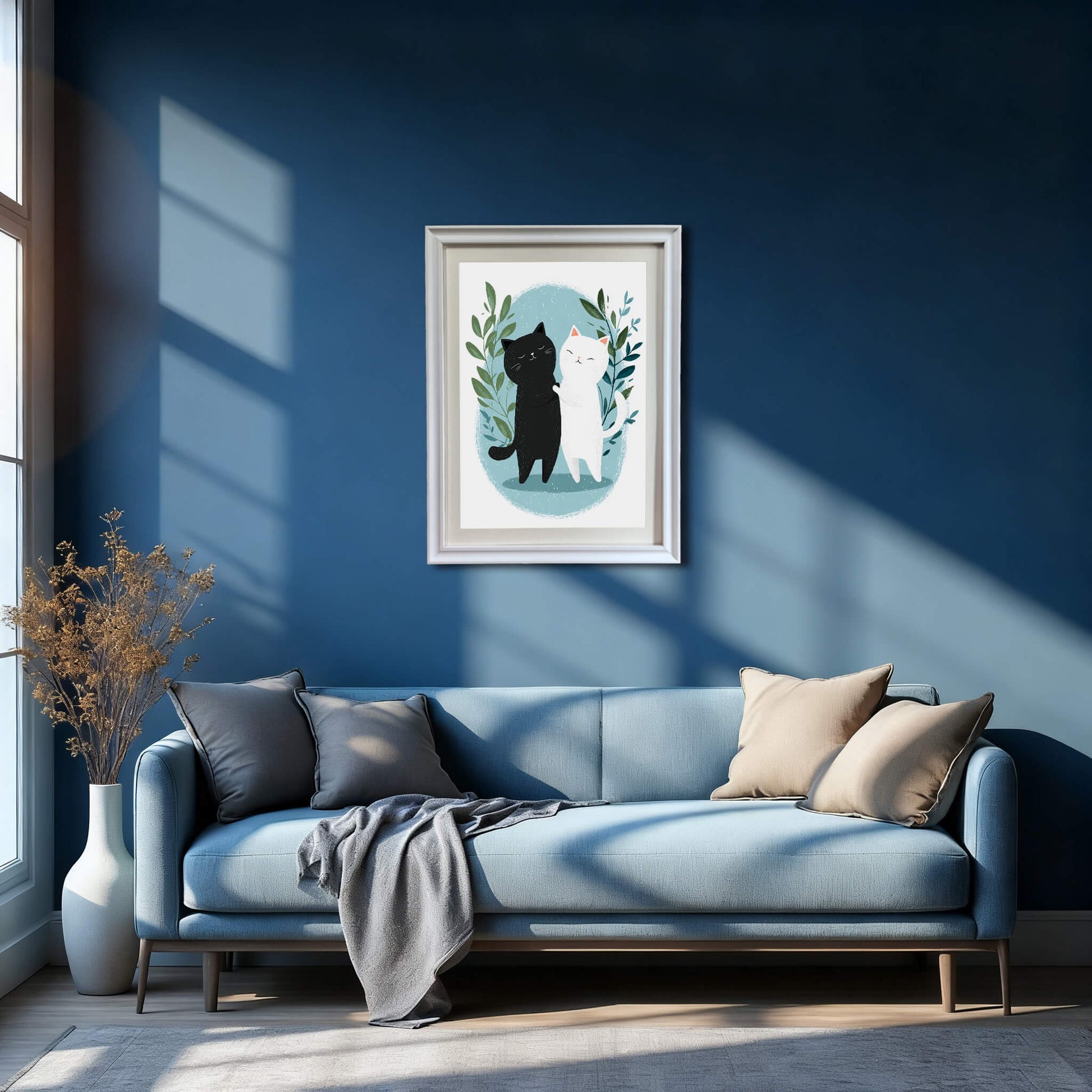 A wide interior shot of a modern living room with deep blue walls. A white-framed print of the hugging cats is centered above a light blue sofa adorned with grey and tan pillows.