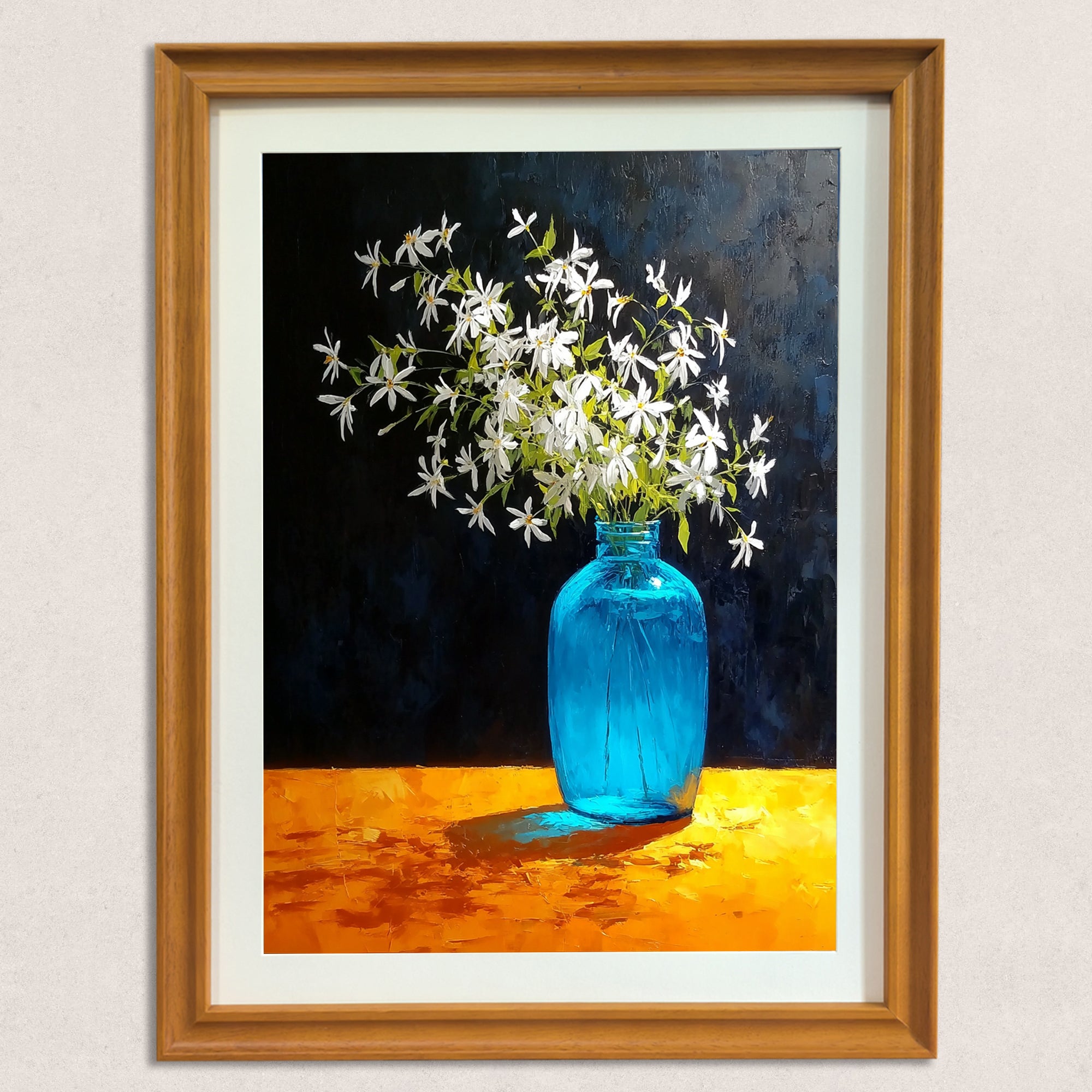 A close-up of the art print in a natural wood-grain frame. The artwork is a still life painting of white jasmine-like flowers in a luminous blue glass bottle on an impasto orange table, with a deep navy blue background.