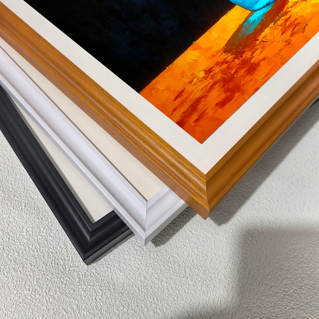 A stack of frame corners: black, off-white, white, and a light wood grain (brown). This displays the different framing options for the blue vase and white flowers art print.
