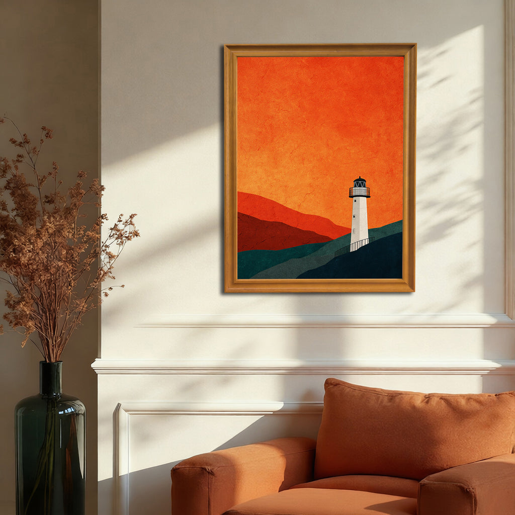 Minimalist graphic print of a white lighthouse against a fiery orange sky, in a gold-colored frame, hanging on a beige wall above an orange armchair.