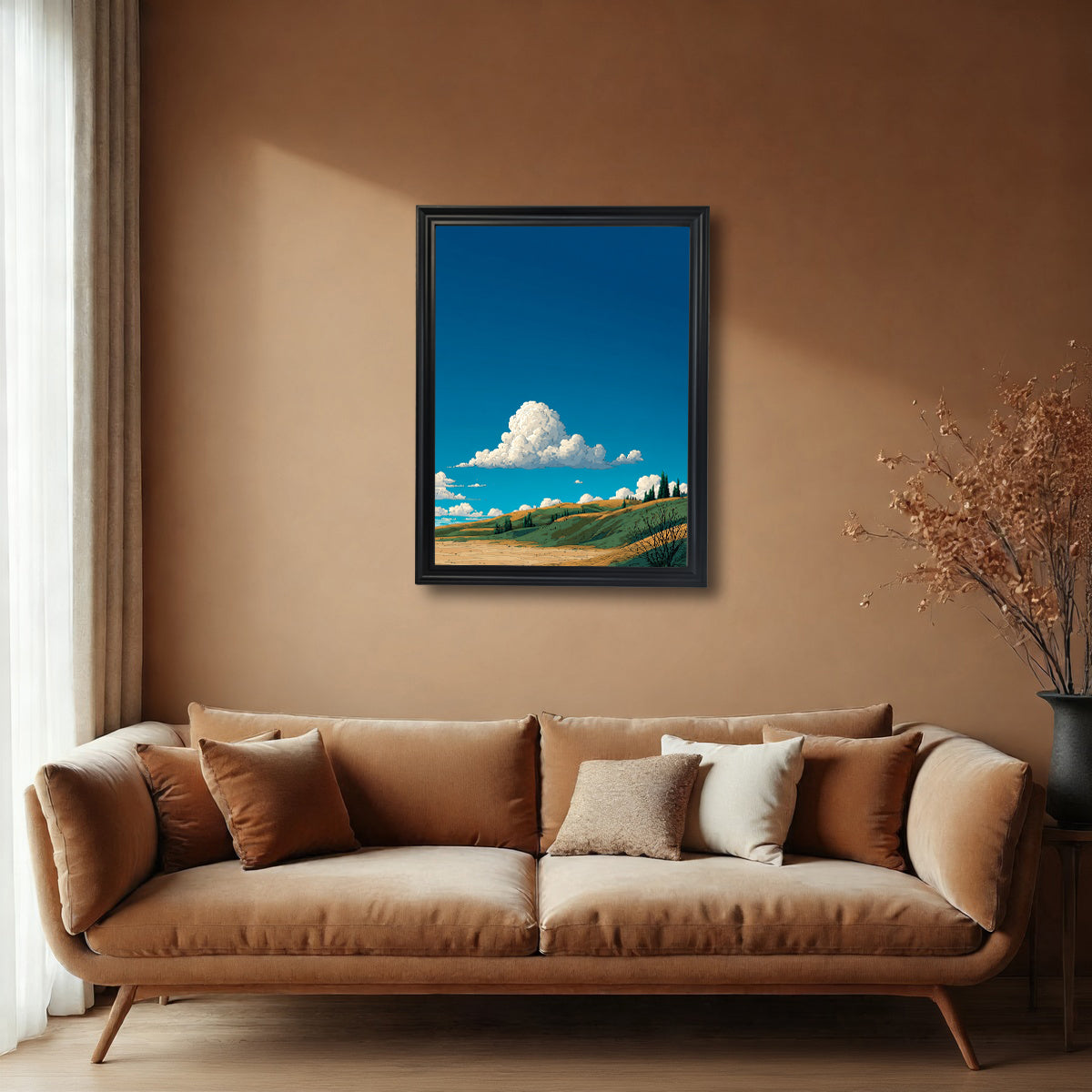 A black-framed art print hanging on a warm brown-toned wall above a large velvet sofa. The artwork features a minimalist, vibrant landscape of green and gold hillsides under a vast blue sky with a single fluffy cloud.