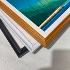 Close-up corner detail of the art print showing three stacked frame options: , white, orange, and black.