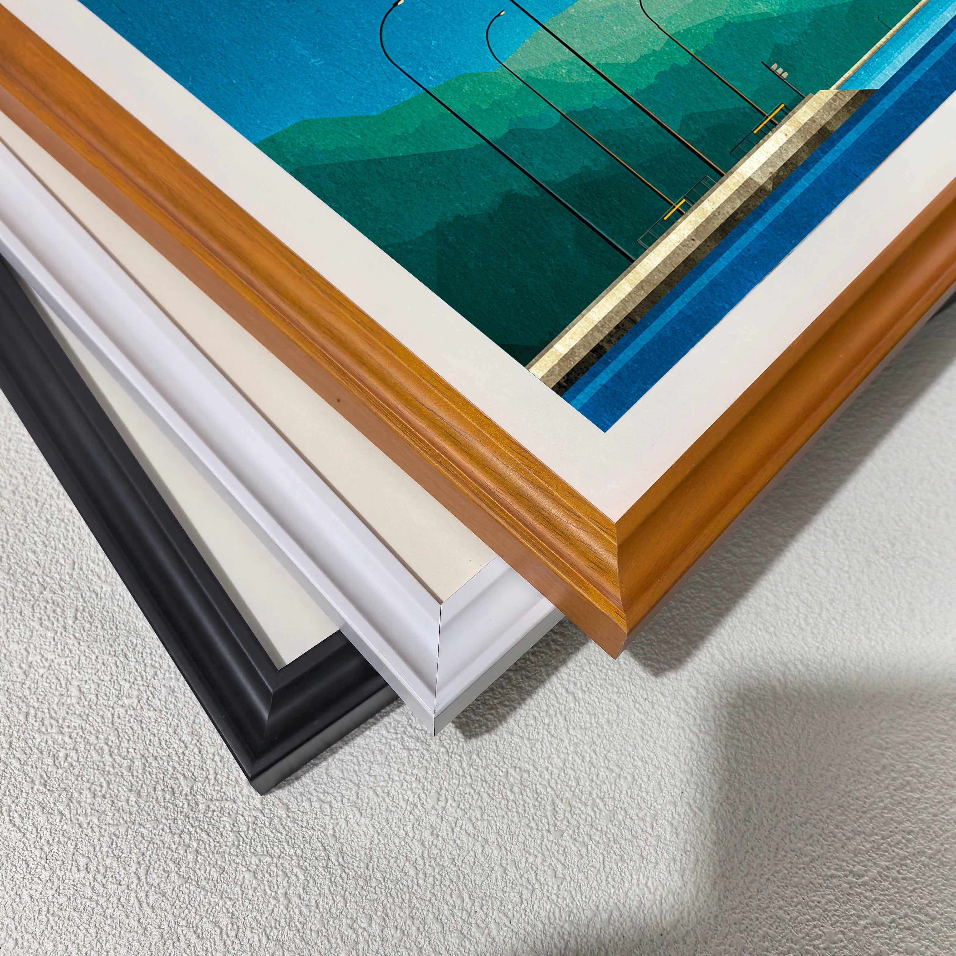 Close-up corner detail of the art print showing three stacked frame options: , white, orange, and black.