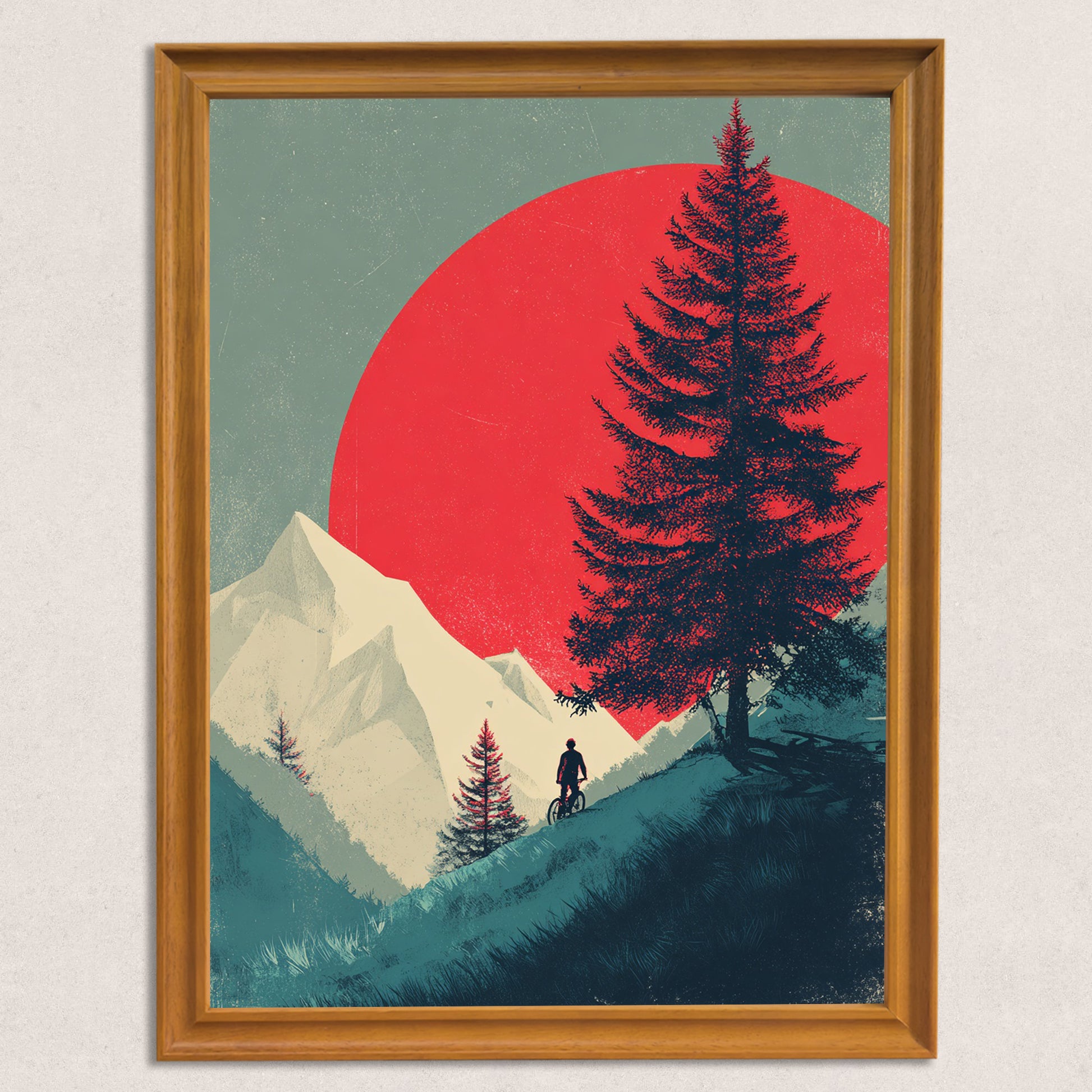 Minimalist art print of a person mountain biking on a hill in front of a white mountain, a large pine tree silhouette, and a vibrant red sun, framed in natural wood.