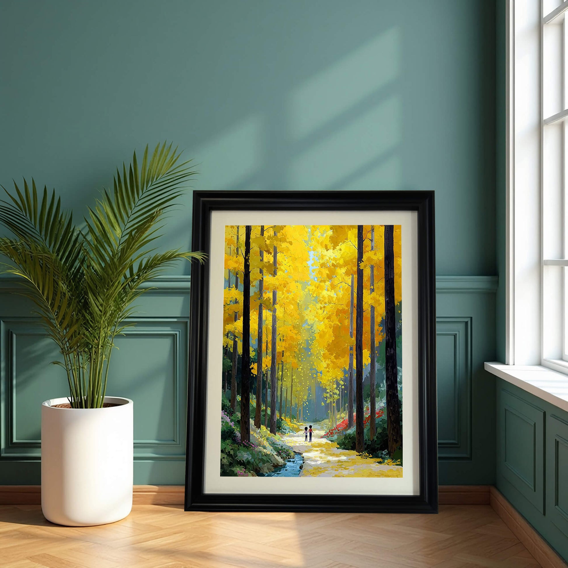 A framed impressionist painting of a golden forest path leaning against a teal wall next to a large potted palm plant.