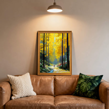 The wood-framed forest painting displayed on a wall above a brown leather sofa, flanked by a knit cream pillow and a green botanical print pillow.