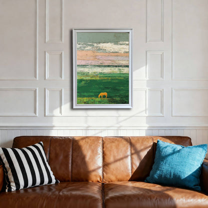 A framed art print of an abstract green landscape with a golden horse, hanging on a white wainscoted wall above a brown leather sofa. The frame is white.