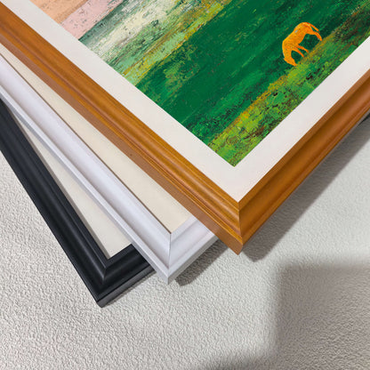 A stack of wood picture frame corners showing different color options: natural wood, white, cream/off-white, and black. A corner of the abstract art print, showing the textured green field and golden horse, is visible on top.