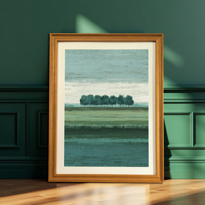 Vertical abstract landscape art print in a warm natural brown wood frame, resting on a wooden floor against a dark emerald green paneled wall.