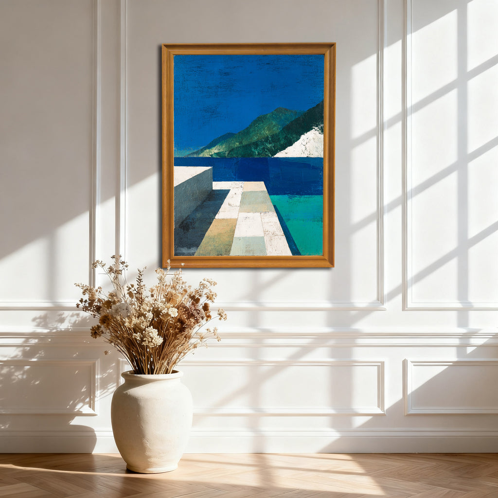 Gold or natural wood-framed abstract landscape art print hanging on a white paneled wall with strong window shadows. A large, cream-colored vase with dried flowers is on the floor.