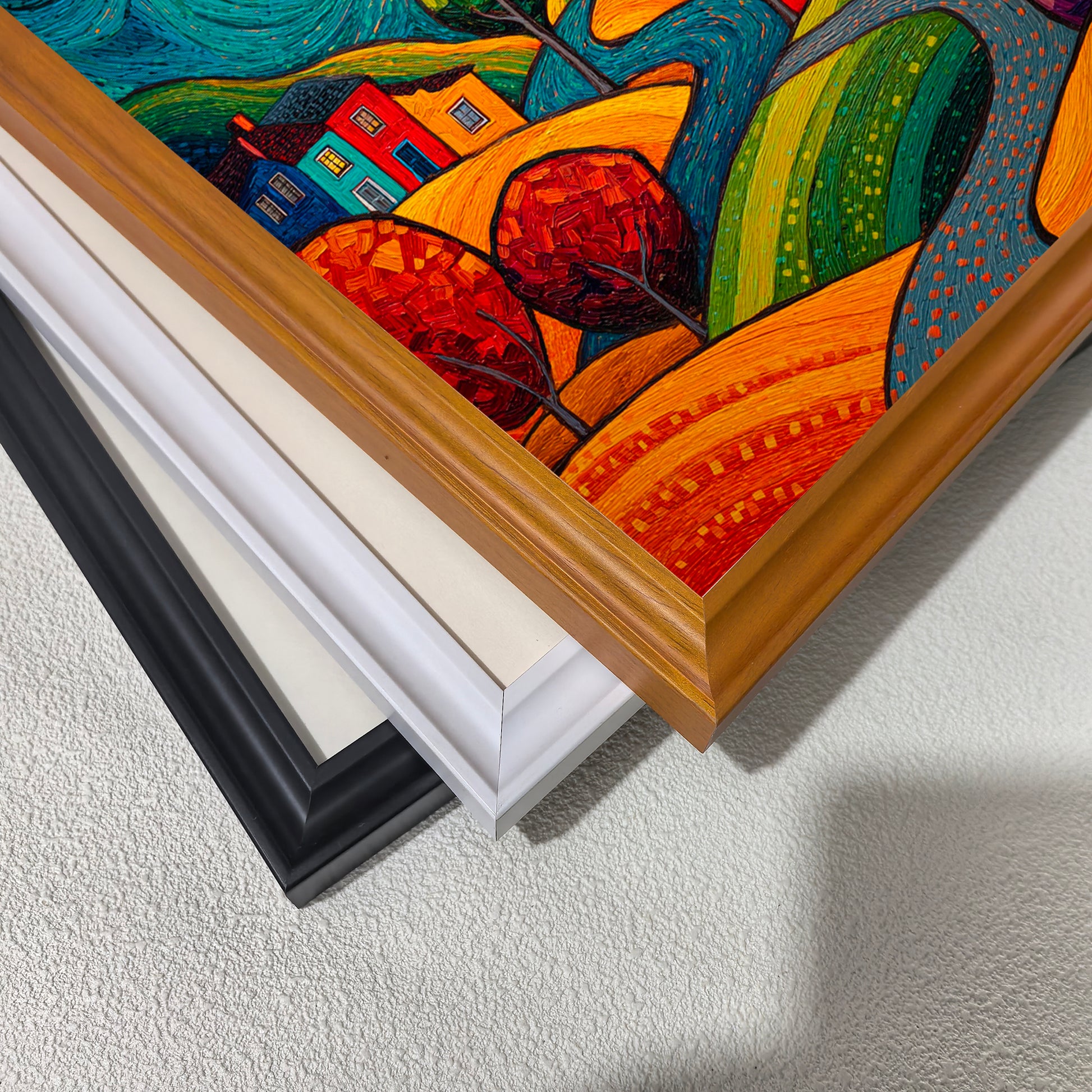 A corner close-up showing the textured folk-art painting and three stacked frame options: warm wood, white, and black, along with a cream mat border.