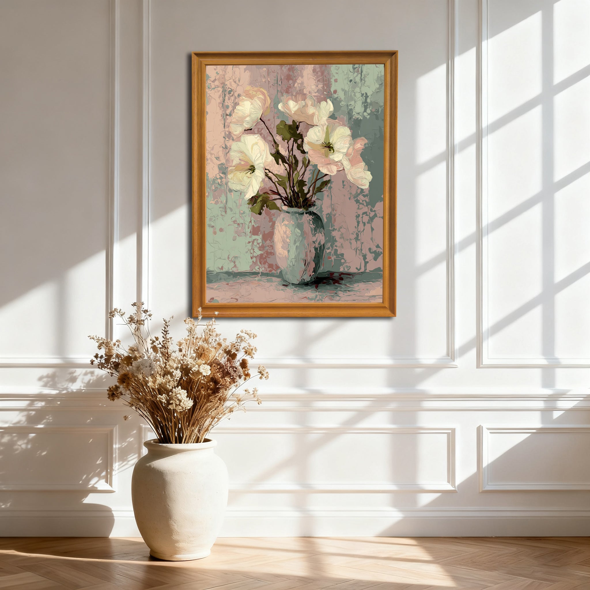 Impressionist floral art print of white and pink flowers in a pale vase against a pastel pink and mint green background, framed in light wood, hanging on a white wainscoting wall with natural light.