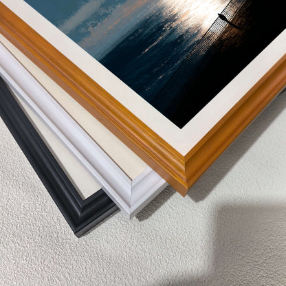 Stacked close-up of different wood frame options for art prints: black, white, and natural light wood (oak/maple). Highlights the mat and frame molding detail and finish.