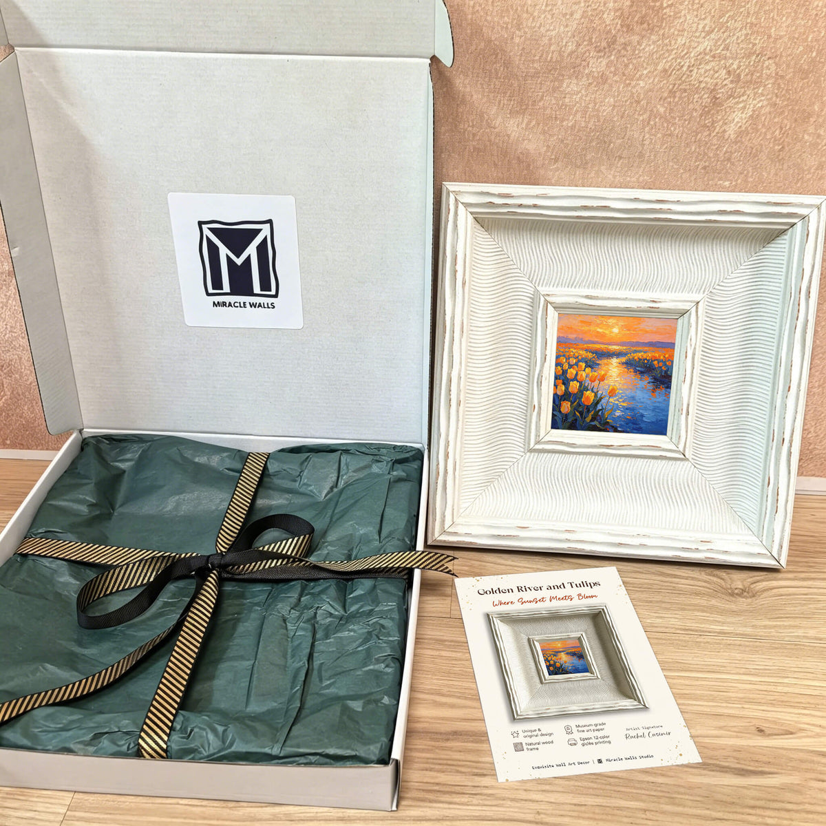 A framed painting titled "Golden River and Tulips Where Sunlight Pretty Bloom" with a white distressed frame. The painting is packaged in a white box with a black and gold ribbon. The box has a "Miracle Walls" logo.