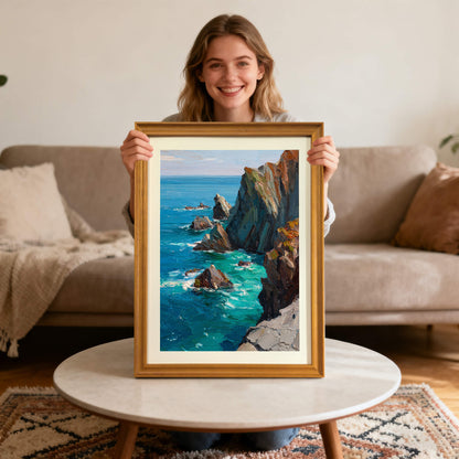 A woman smiling and holding a framed impressionist oil painting of a rocky coastline with vibrant blue and turquoise water.